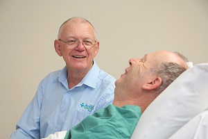 Photograph of a man talking with a patient