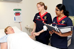 Photograph of two nurses with a patient