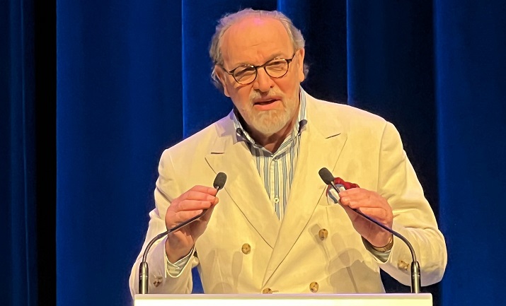 Photograph of Gerald Watts holding 2 microphones